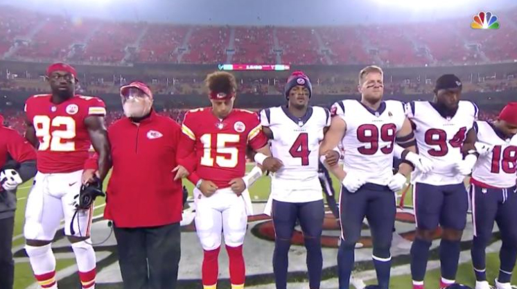 The Kansas City Chiefs and Houston Texans link arms in a moment of unity prior to their season-opening game on Sept. 10.