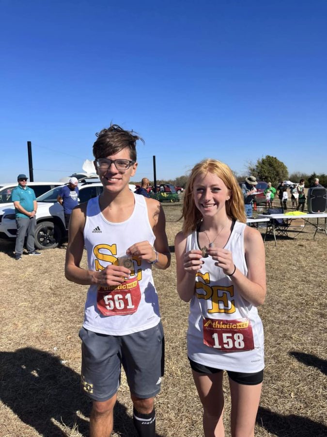 Senior Jake Beauchump and
Freshman Emma McCormick pose
with their metals from
regionals.