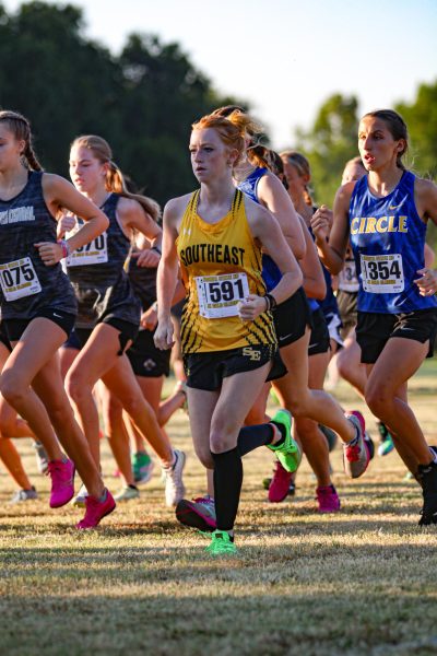 Emma McCormick (10) running at a Wichita State cross country meet. 