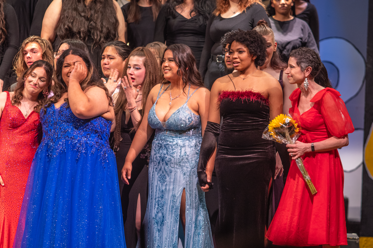 Senior members of the choir console each other during an emotional ending to the final performance of Goldust on May 3. Students and alumni surprised Cookson with a slideshow and special musical performances to commemorate her final Goldust as choir director at Southeast.