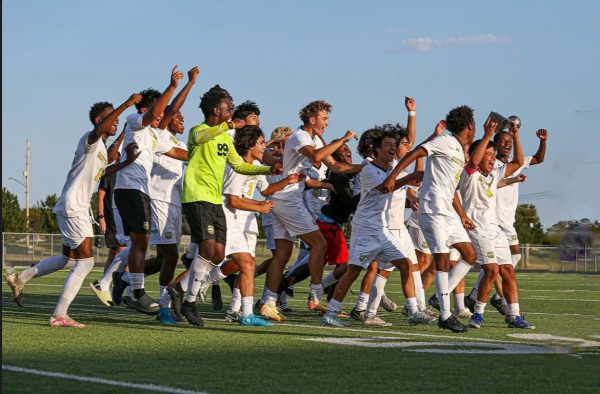 The Southeast varsity boys soccer team celebrates after winning the Maize South tournament.