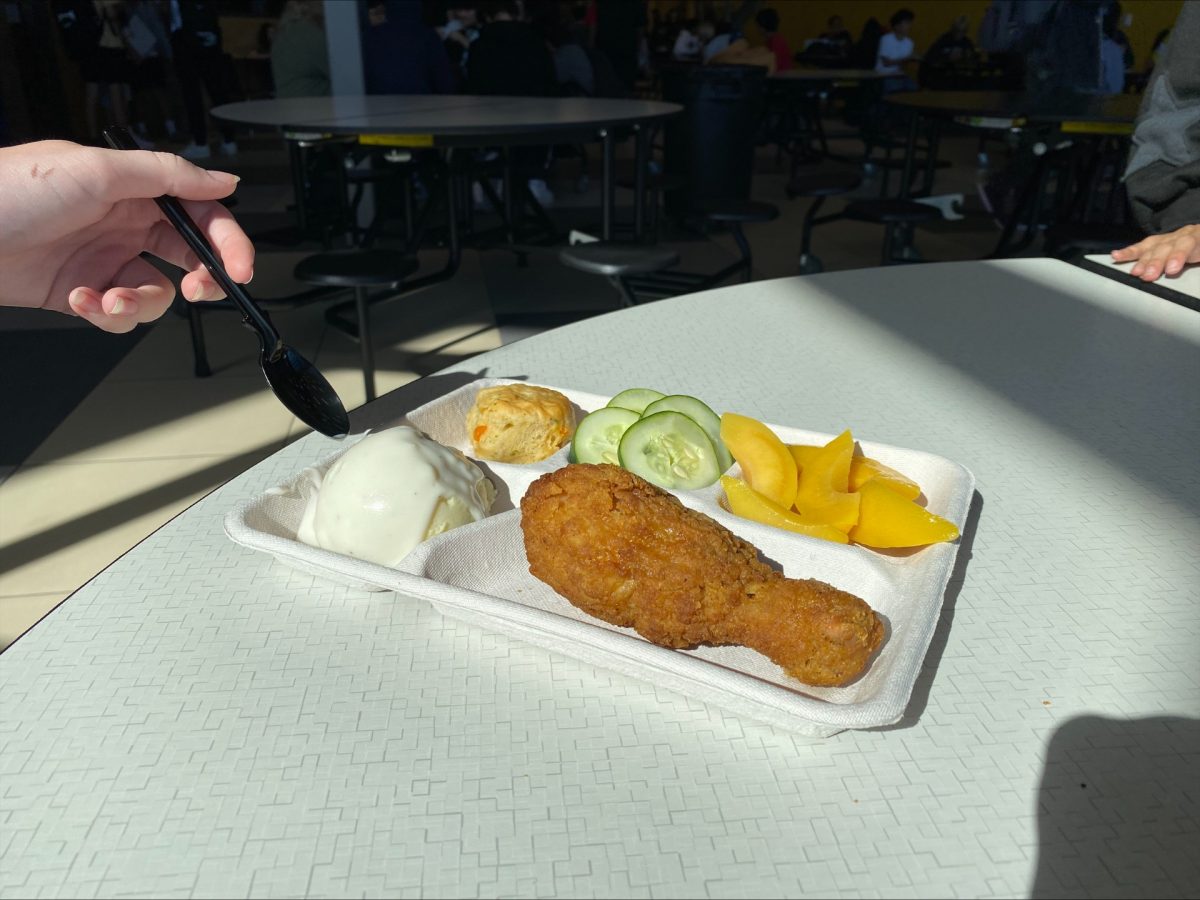 A student dives into their lunch. Some of the items on this tray likely came from local sources.