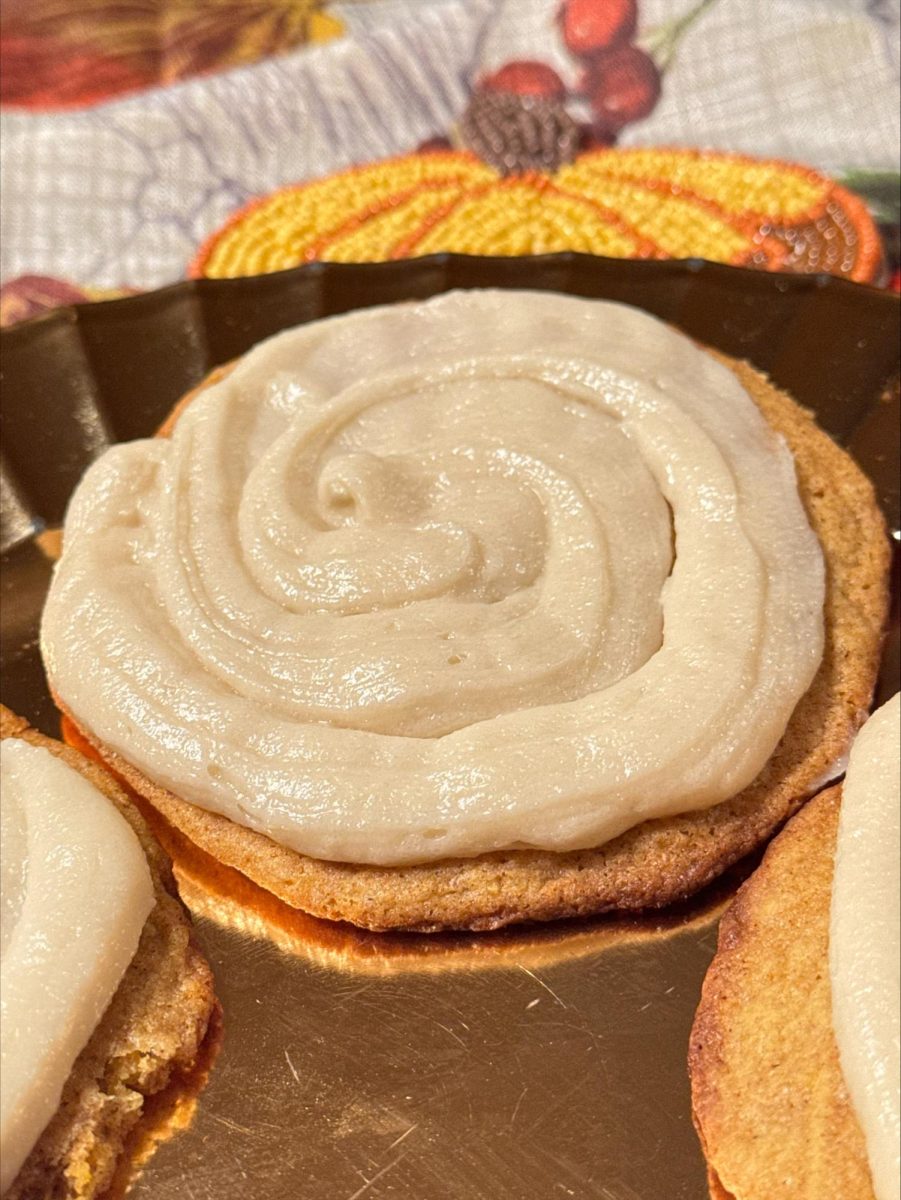 Cream cheese frosting  piped onto snickerdoodle cookie