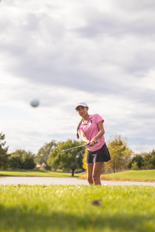 Alina Lam practices her chip shot. Lam won the City League title and took 4th place at this year's 6A championship.